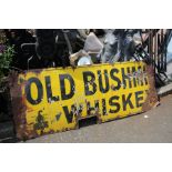 Old Bushmills Whiskey; a yellow enamel advertising sign