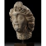 A ROMAN BASALT HEAD OF A WOMAN "HAURAN", CIRCA 2ND CENTURY A.D.