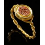 A ROMAN RED JASPER INTAGLIO OF A BEE WITH GOLD RING, CIRCA 1ST-2ND CENTURY A.D.