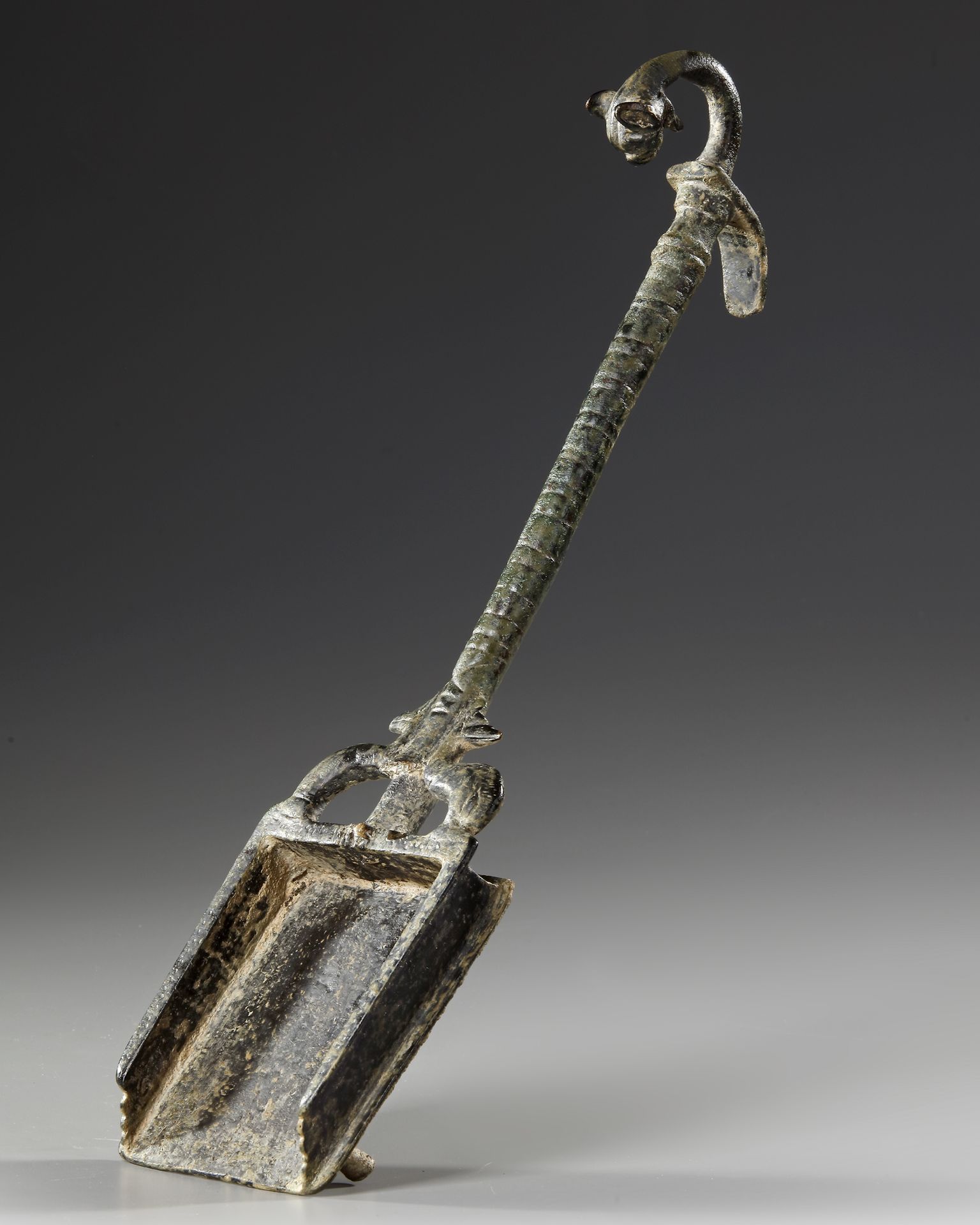 A ROMAN BRONZE INCENSE SHOVEL WITH A PANTHER HEAD, CIRCA 1ST-2ND. A.D.