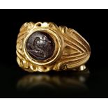 A ROMAN GOLD RING WITH DARK GREEN JASPER INTAGLIO, CIRCA 3RD-4TH CENTURY A.D.