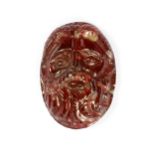 A ROMAN GARNET FACE OF ZEUS, CIRCA 2ND-3RD CENTURY A.D.