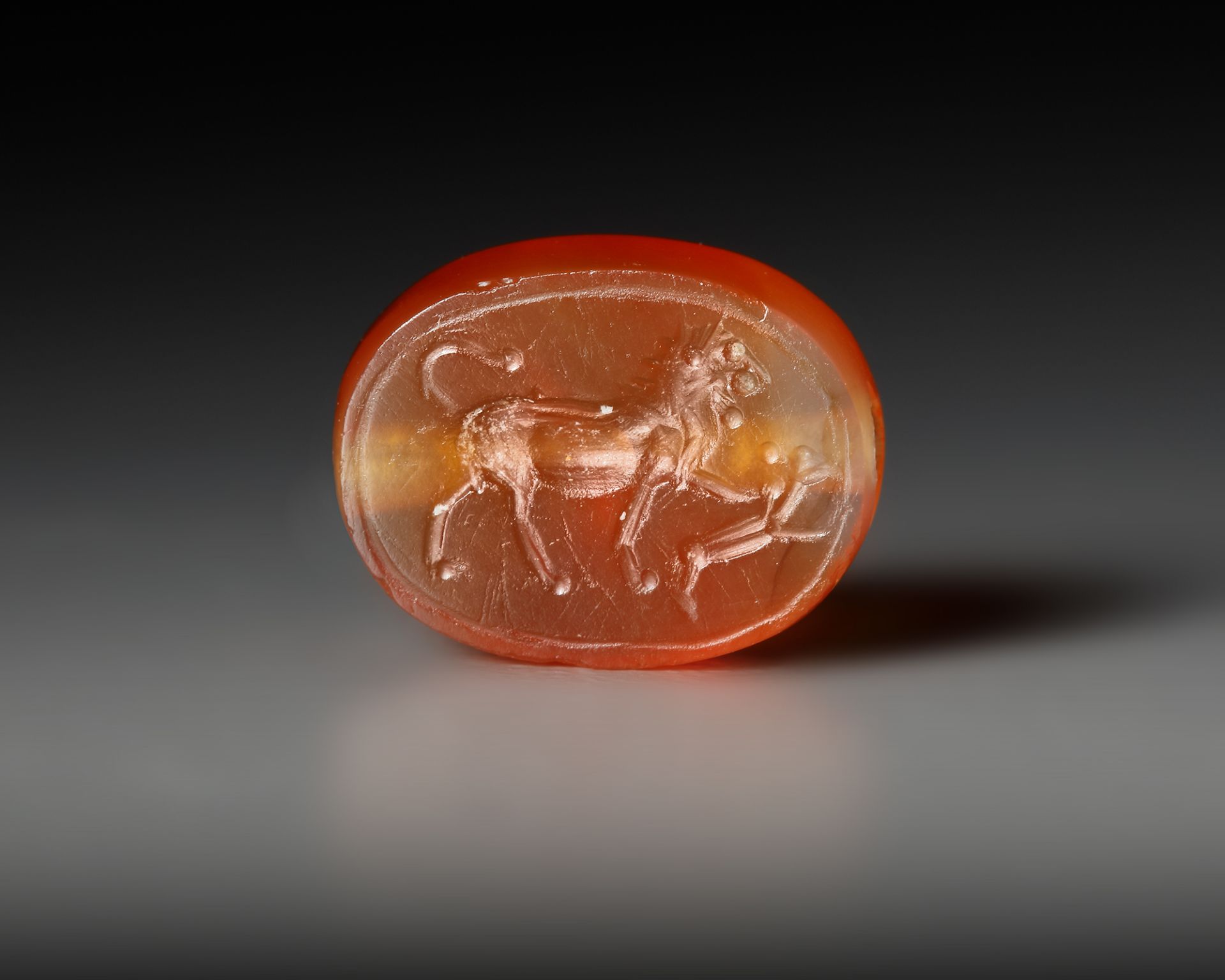 AN EASTERN GREEK CARNELIAN SCARABOID SEAL WITH LION, CIRCA 5TH CENTURY B.C.