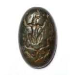 A ROMAN GREEN MOTTLED JASPER MAGICAL GNOSTIC INTAGLIO WITH ANUBIS SEATED, CIRCA 3RD-4TH CENTURY A.D.