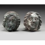A PAIR OF ROMAN BRONZE AND SILVERED "FACE OF FEMALE" TERMINALS, CIRCA 2ND-3RD CENTURY A.D.