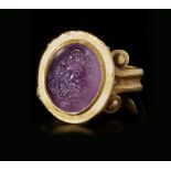 A ROMAN GOLD RING WITH AMETHYST INTAGLIO, CIRCA 2ND-3RD CENTURY A.D.