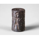 A WESTERN ASIATIC HEMATITE CYLINDER SEAL, CIRCA 1900-1700 B.C.