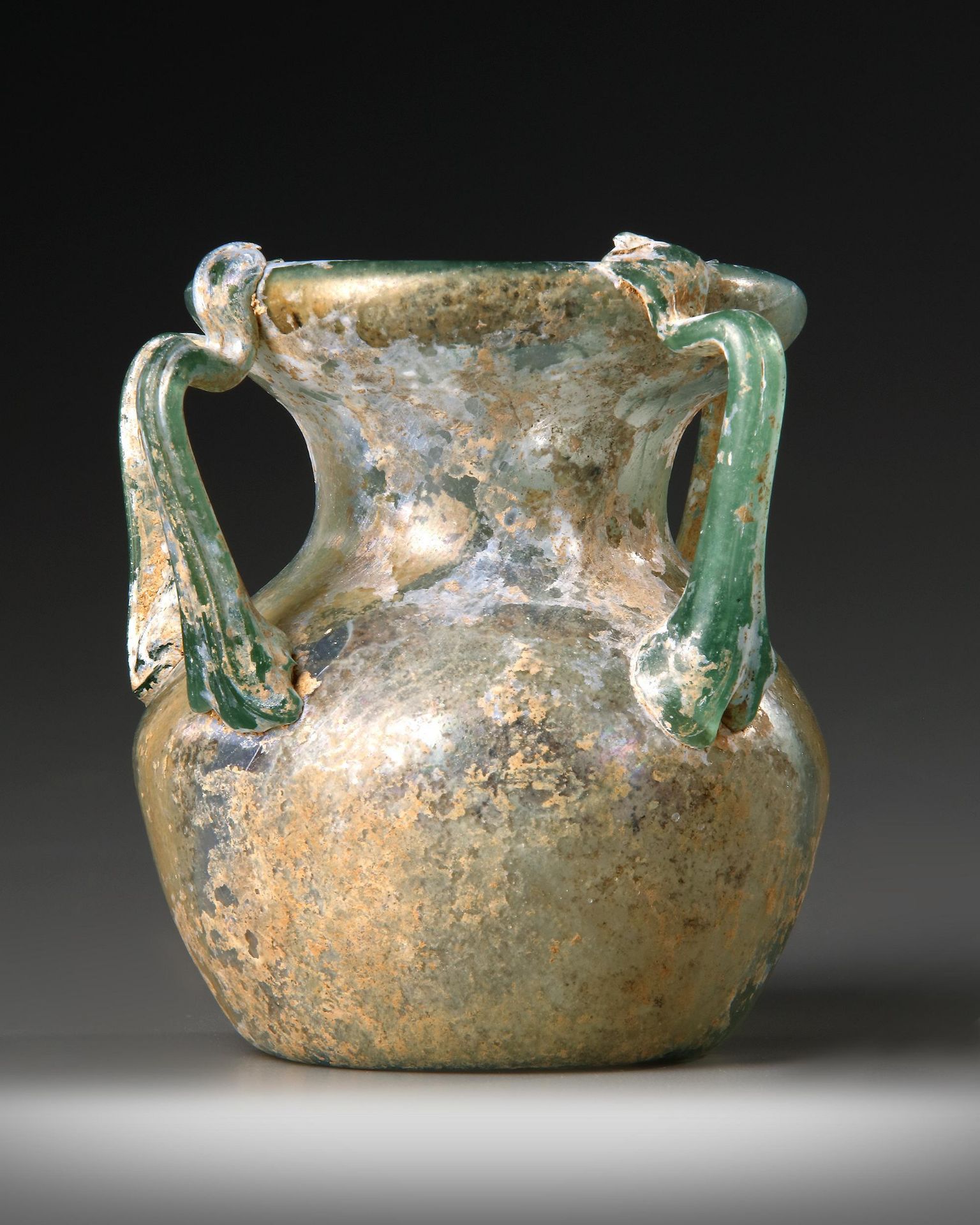 A ROMAN FOUR-HANDLED GREEN GLASS JAR, CIRCA 3RD CENTURY A.D. - Image 3 of 4