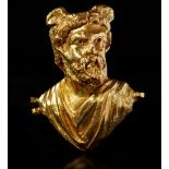 A ROMAN REPOUSSÉ GOLD BUST OF A MAN WITH WINGED HEAD, CIRCA 2ND CENTURY A.D.