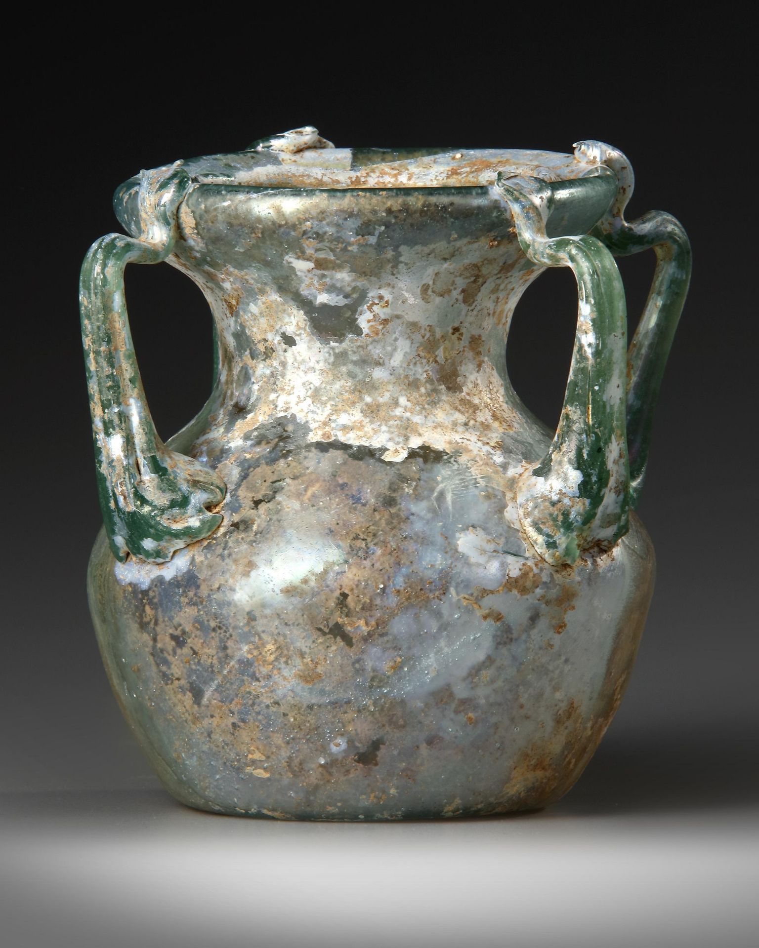 A ROMAN FOUR-HANDLED GREEN GLASS JAR, CIRCA 3RD CENTURY A.D. - Image 4 of 4