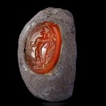 A ROMAN SILVER RING WITH A CARNELIAN INTAGLIO SHOWING MERCURY, CIRCA 2ND-3RD CENTURY A.D.