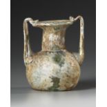 A ROMAN GLASS JAR WITH TWO HANDLES, CIRCA 3RD-4TH CENTURY A.D.