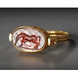 A GREEK GOLD RING WITH GARNET INTAGLIO, HELLENISTIC PERIOD, CIRCA 3RD CENTURY B.C.