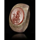 A ROMAN BRONZE RING WITH CARNELIAN INTAGLIO, CIRCA 2ND-3RD CENTURY A.D.