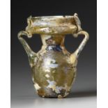 AN INTACT ROMAN OLIVE YELLOW GLASS TWIN-HANDLED JAR, CIRCA 4TH CENTURY A.D.
