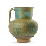 AN IRIDESCENT TURQUOISE BLUE GLAZED POTTERY JUG, KASHAN, 12TH CENTURY