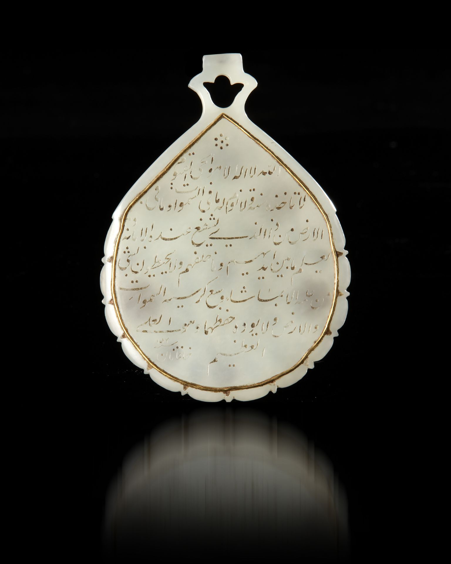 A MUGHAL JADE PENDANT (HALDILI) MUGHAL INDIA, DATED 1013 AH/1607 AD