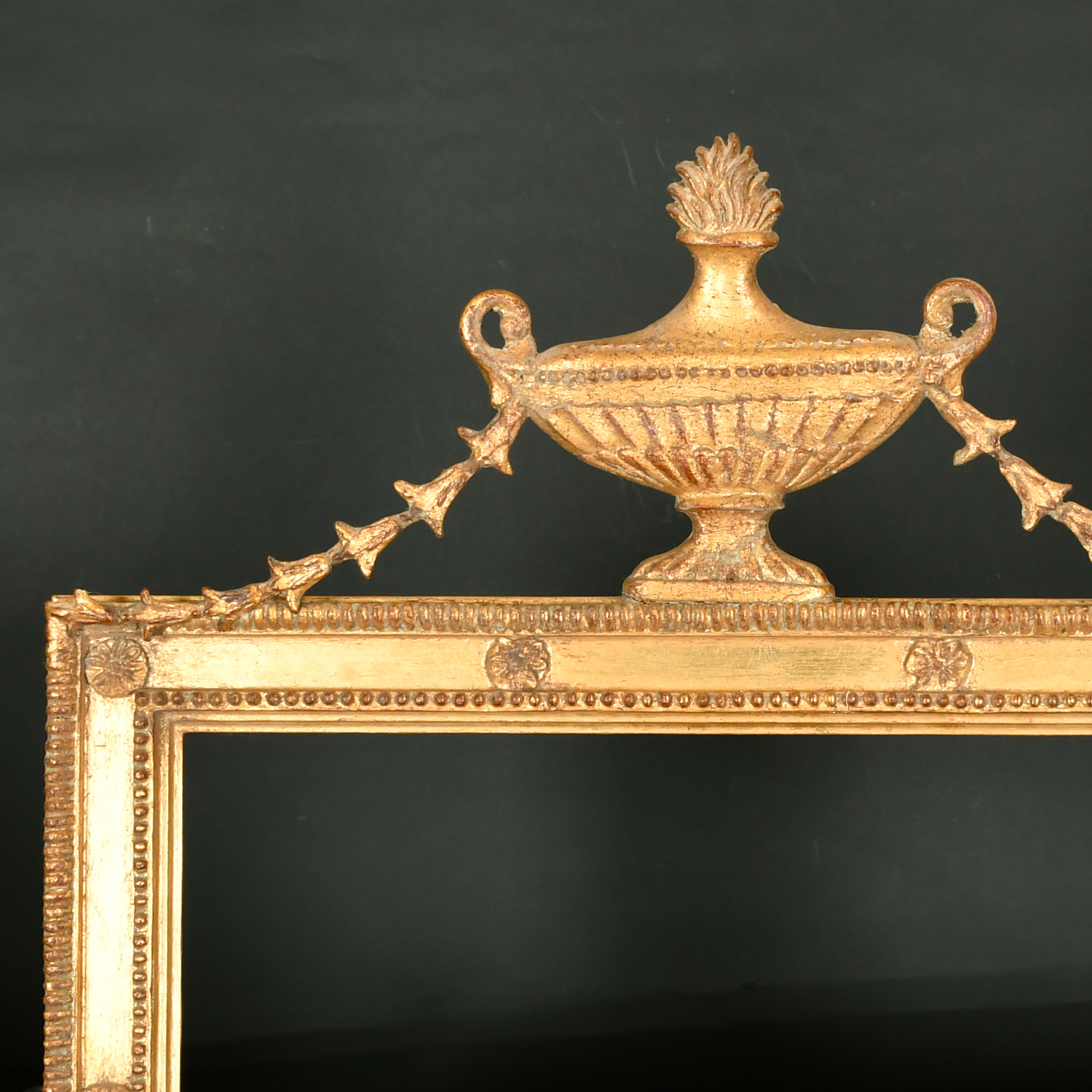 20th Century English School. A Gilt Composition frame, with an ornate top with an urn, rebate 23.25"