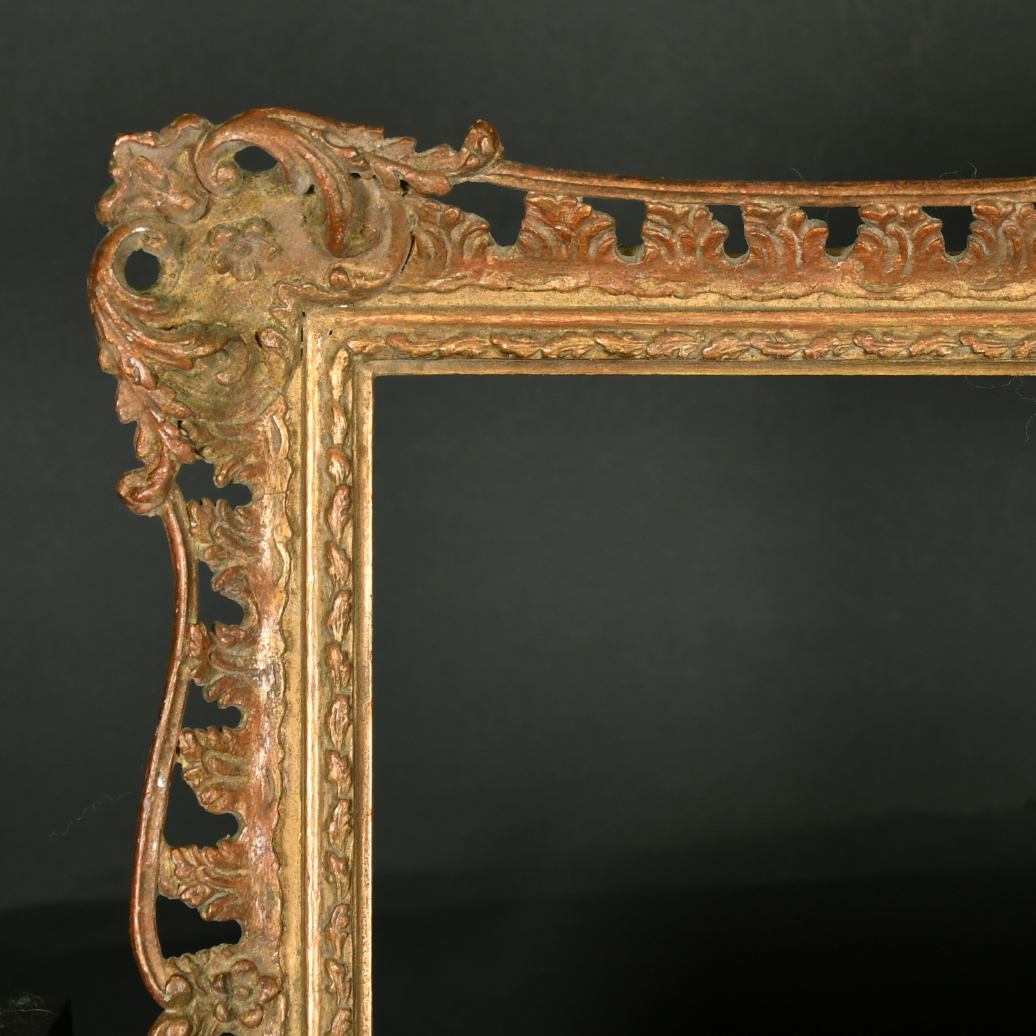 20th Century English School. A Gilt Composition frame with swept and pierced centres and corners,