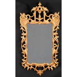Alexander G Ley & Son. A Reproduction Carved Giltwood Chippendale Style Mirror, 50" x 25" (127 x