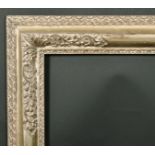 Alexander G Ley & Son. A Reproduction English Carved Silvered Wood Frame, with Lely panels, rebate