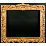 18th Century French School. A Louis XV Carved Giltwood Frame, with swept centres and corners, (a