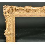 Alexander G Ley & Son. A Reproduction Carved Giltwood Frame, with swept centres and corners,