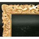 Alexander G Ley & Son. A Reproduction Carved Giltwood Florentine Frame, rebate 44" x 31.5" (111.7