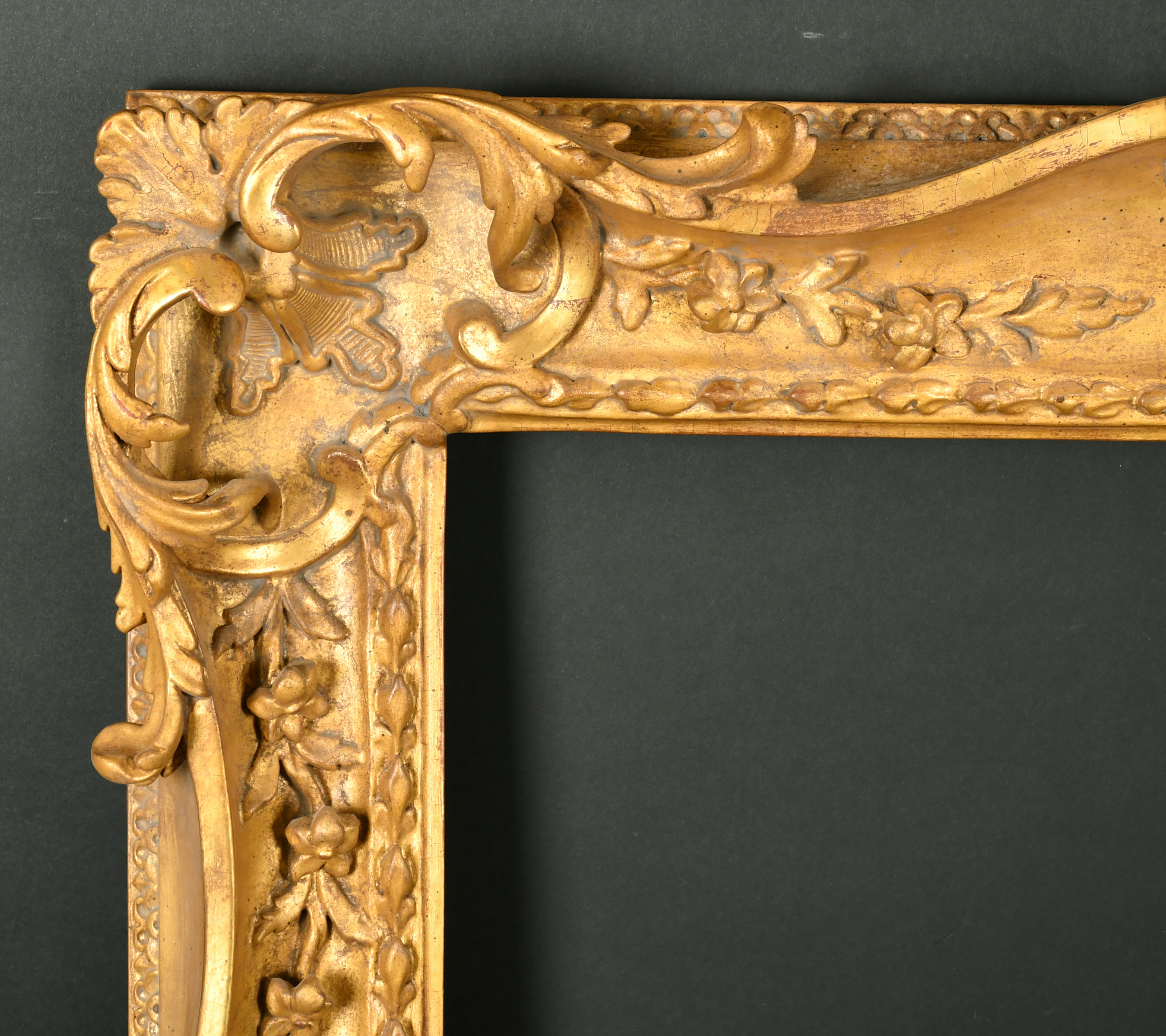 Alexander G Ley & Son. A Reproduction Carved Giltwood Frame, with swept and pierced centres and