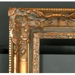 19th Century French School. A Gilt Composition Frame with swept centres and corners, rebate 18" x