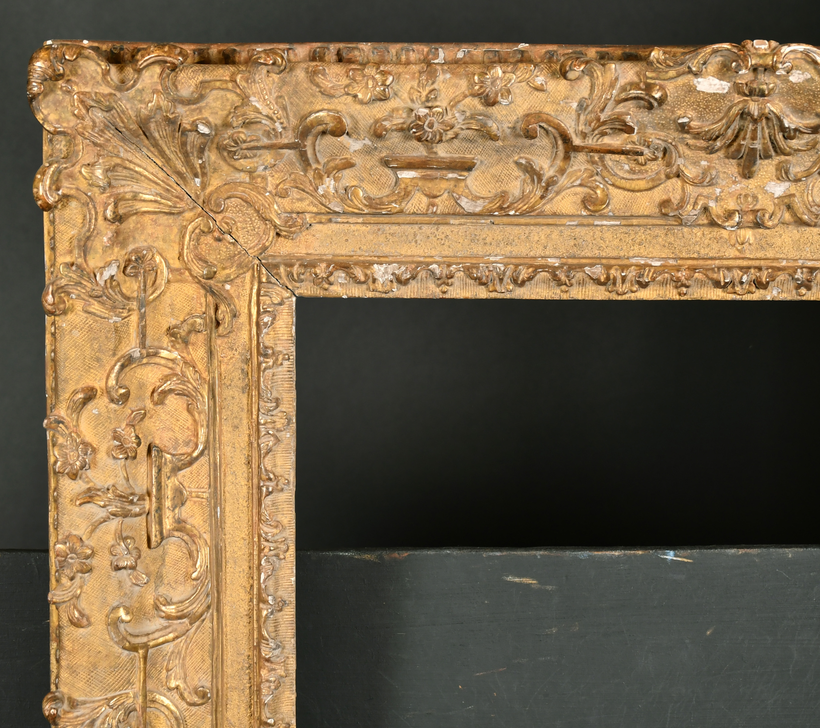 18th Century French School. A Regence Carved Giltwood Frame, with swept centres and corners,