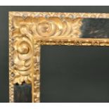 Alexander G Ley & Son. A Reproduction Spanish Style Black and Gold Carved Giltwood Frame, rebate