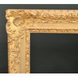 Alexander G Ley & Son. A Reproduction Carved Giltwood Frame, with swept centres and corners,