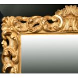 Early 19th Century Italian School. A Carved Giltwood Florentine Frame, with inset mirror glass,