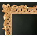 20th Century English School. A Carved Giltwood Frame, with swept and pierced centres and corners,