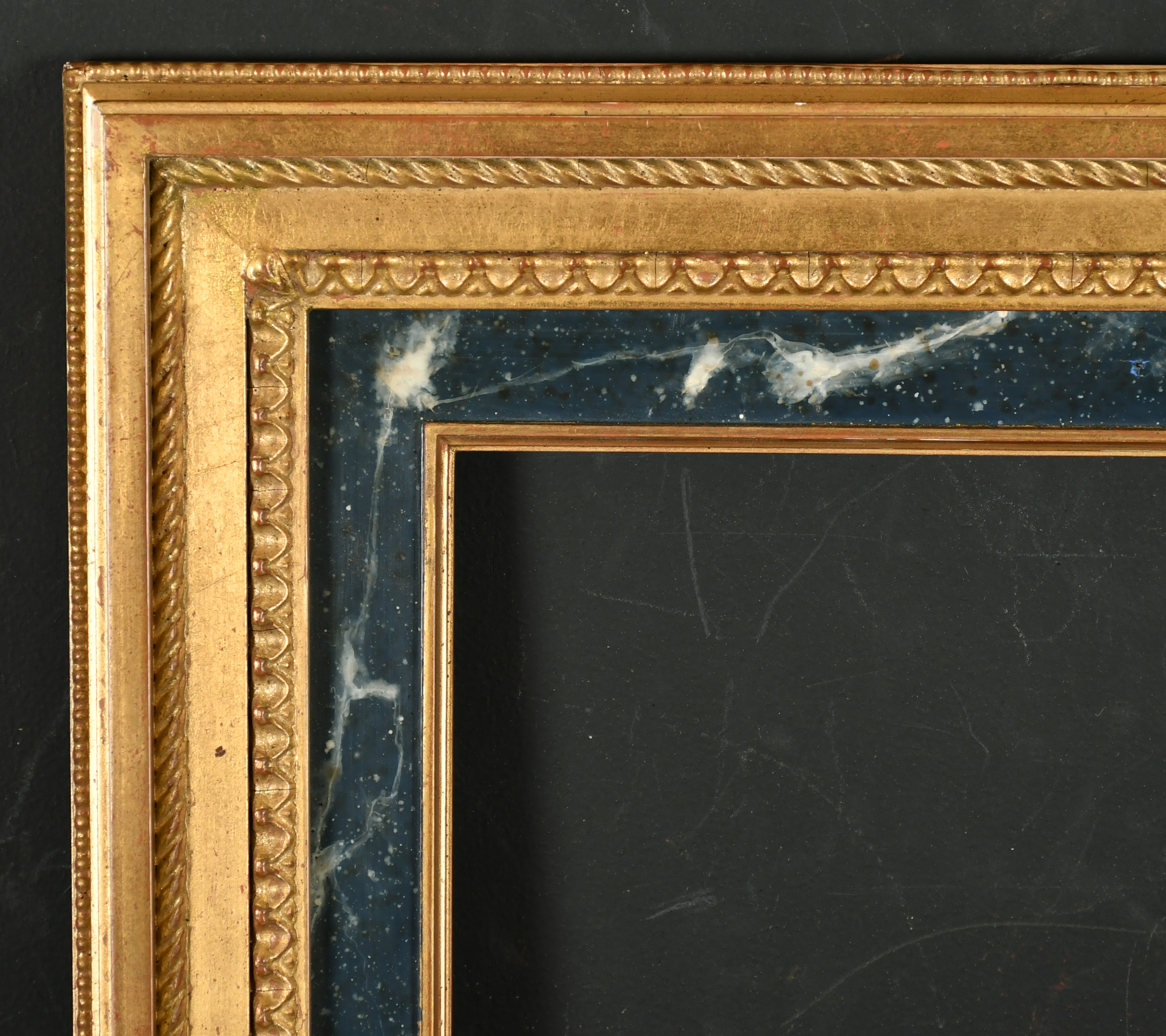 20th Century English School. A Gilt Composition Frame, with a printed marble effect slip, rebate