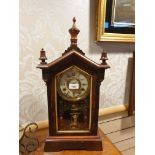 Antique mantel clock with hand painted fronted glass and lovely designed 3 section top.