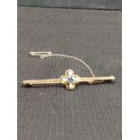 15ct gold blue stone and pearl set bar brooch .