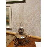 Brass oil lamp set on cast iron support.