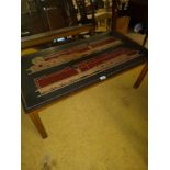 Mid century teak table with train designed top in leather .