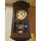 Art Deco wall clock with pendulum.