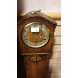 Oak cased grandmother clock with key no pendulum but ticks.
