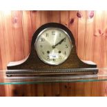Large oak cased mantel clock with key and pendulum.