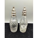 Pair of silver hall marked topped bottles with glass sugar sifters .