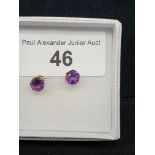 Gold and amethyst stud earrings.