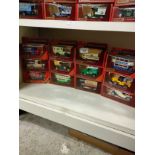 Shelf of matchbox yesteryear advertising van s , car etc models .