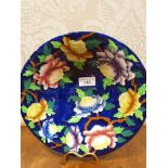 Maling blue lustre backgrounded bowl / wall charger with flower design .