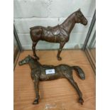 Pair of cast metal horse plaque s with bronze finish .