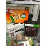 Shelf of Xbox 360 kinnect boxed together with Xbox boxed halo reach item etc .
