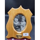 Large Mauchline ware sheild shaped photo frame with Blackfoot scene to bottom.